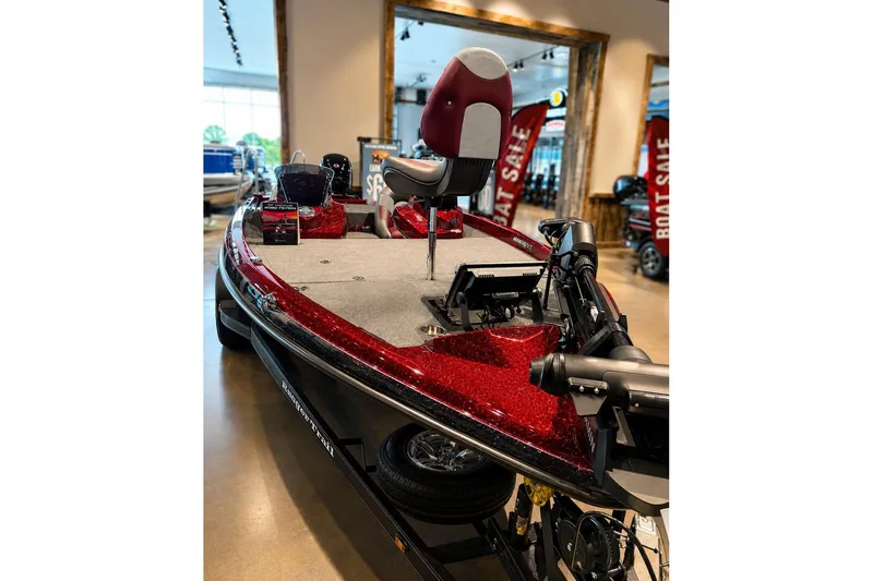 Slide: The Image of 2026 Ranger Z185 boat with red accents displayed in showroom, featuring advanced navigation equipment. - 1