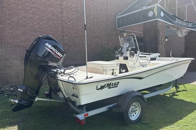 Slide: The Image of 2026 Mako Pro Skiff 15 CC boat with Mercury engine on trailer. - 2