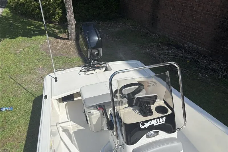 Slide: The Image of 2026 Mako Pro Skiff 15 CC boat with steering console and outboard motor. - 9