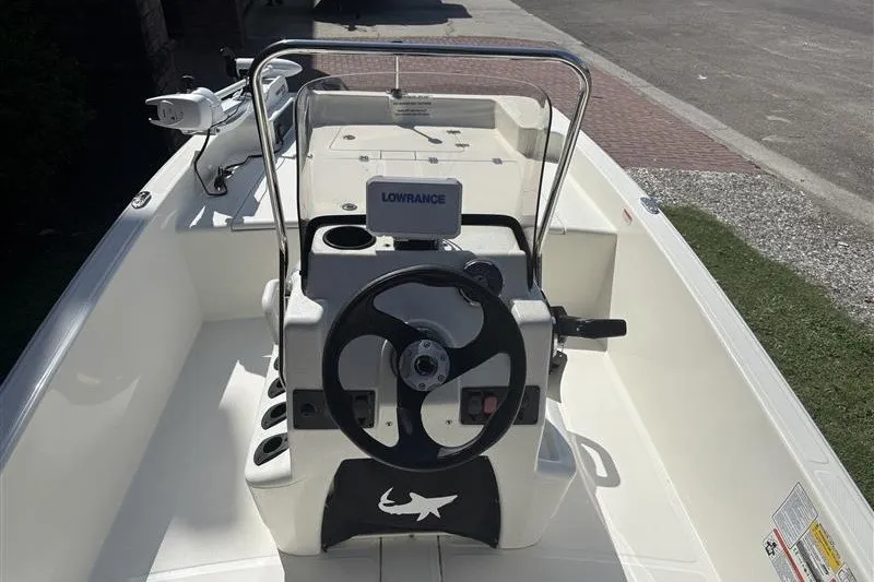 Slide: The Image of 2026 Mako Pro Skiff 15 CC boat interior with steering wheel and navigation system. - 5