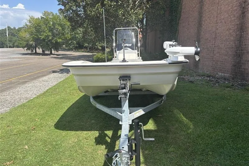 Slide: The Image of 2026 Mako Pro Skiff 15 CC boat on trailer, parked on grass. - 3