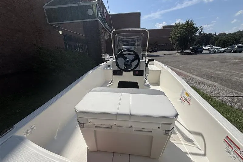 Slide: The Image of 2026 Mako Pro Skiff 15 CC boat interior with steering console and seating. - 7