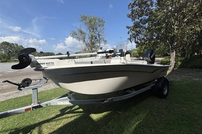 Slide: The Image of 2026 Mako Pro Skiff 15 CC boat on trailer, equipped with Minn Kota motor. - 4