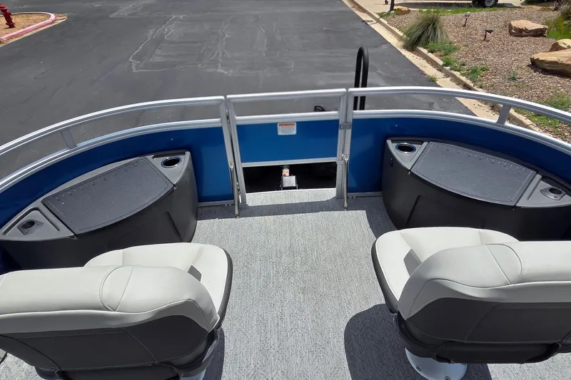Slide: The Image of 2026 Sun Tracker Fishin' Barge 20 DLX interior with seating and storage compartments. - 17