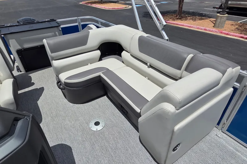 Slide: The Image of 2026 Sun Tracker Fishin' Barge 20 DLX interior with gray and white seating. - 19
