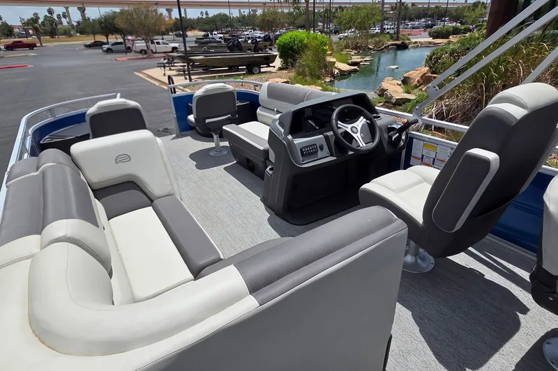 Slide: The Image of 2026 Sun Tracker Fishin' Barge 20 DLX interior with seating and steering console. - 14