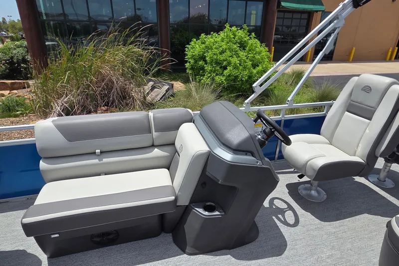 Slide: The Image of 2026 Sun Tracker Fishin' Barge 20 DLX interior with seating and steering console. - 18