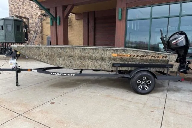 The Image of 2026 Tracker Grizzly 1756 T Marsh boat on trailer, parked outside a building. - 0