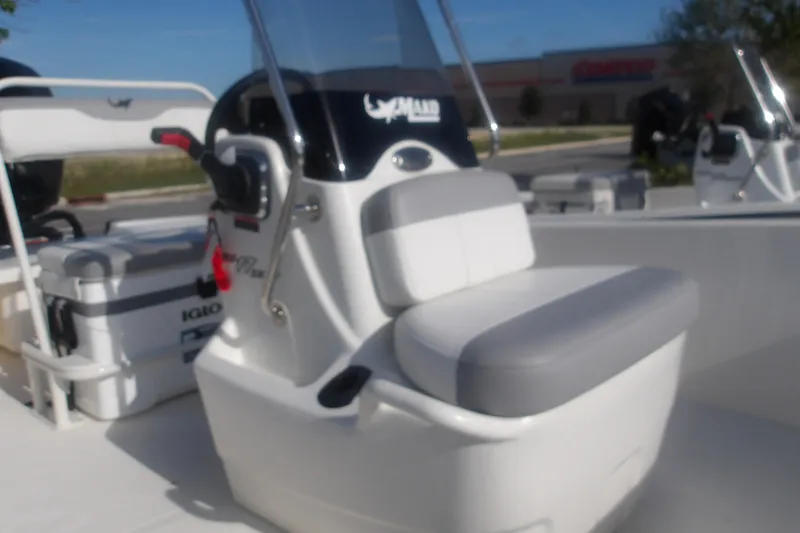 Slide: The Image of 2026 Mako Pro Skiff 17 CC boat interior with seating and console. - 17