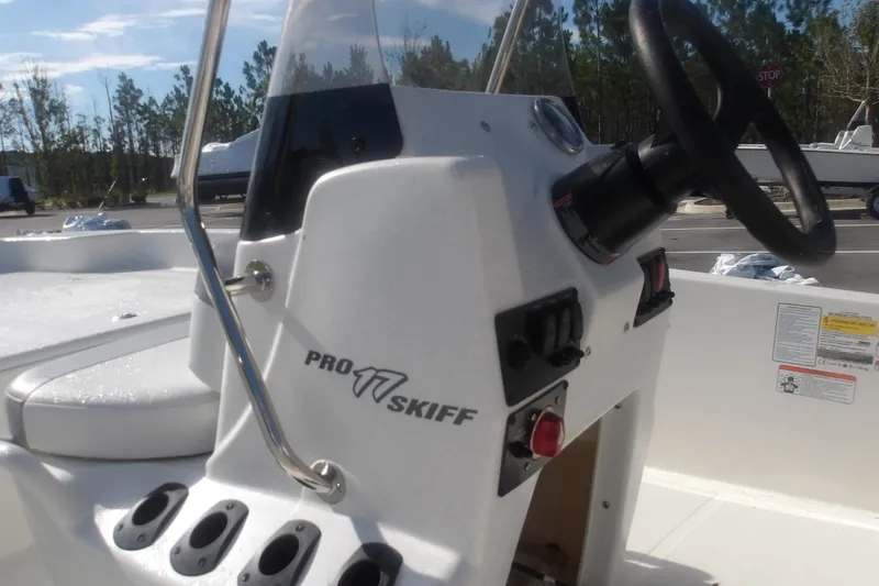 Slide: The Image of 2026 Mako Pro Skiff 17 CC boat console with steering wheel and controls. - 10