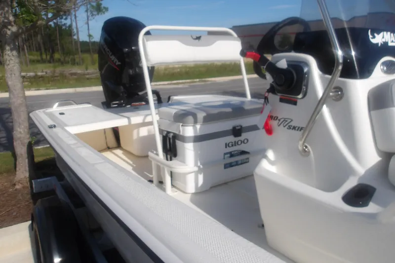 Slide: The Image of 2026 Mako Pro Skiff 17 CC boat with Igloo cooler and Mercury engine. - 16