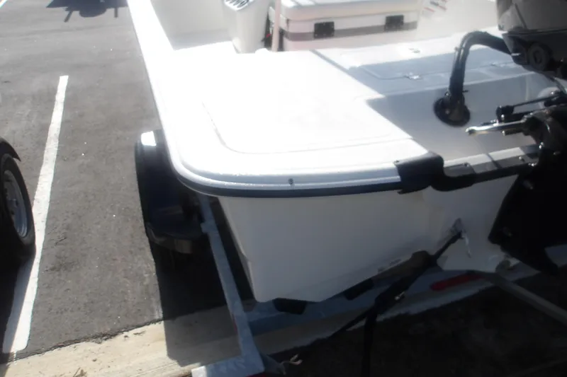 Slide: The Image of 2026 Mako Pro Skiff 17 CC boat on trailer, rear view, in parking lot. - 12