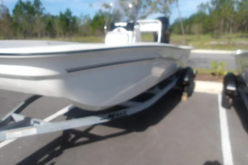 Slide: The Image of Blurry image of a 2026 Mako Pro Skiff 17 CC boat on a trailer. - 3