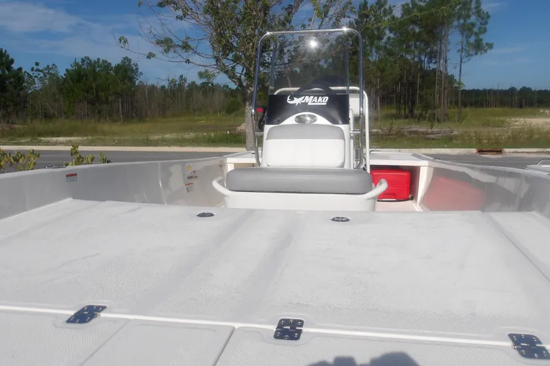 Slide: The Image of 2026 Mako Pro Skiff 17 CC boat with console and seating, outdoors in a natural setting. - 7