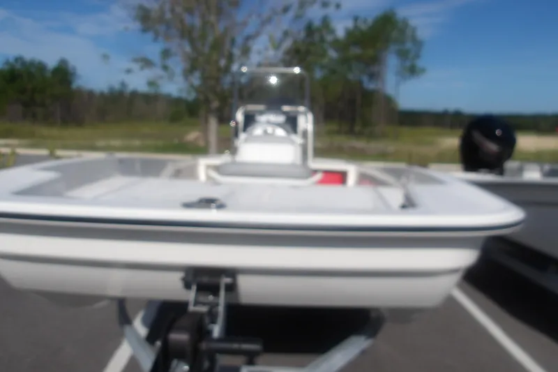 Slide: The Image of Blurry image of a 2026 Mako Pro Skiff 17 CC boat on a trailer. - 5