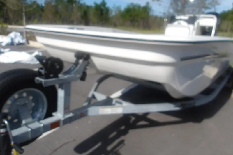 Slide: The Image of 2026 Mako Pro Skiff 17 CC on trailer, parked outdoors, side view. - 4