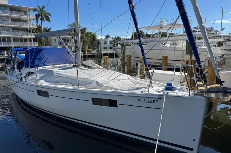 The Image of 2019 Beneteau Oceanis 41.1 sailboat docked at marina, blue canopy, sunny day. - 0