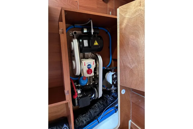 Slide: The Image of Engine compartment of a 2019 Beneteau Oceanis 41.1 sailboat, showcasing mechanical components. - 13