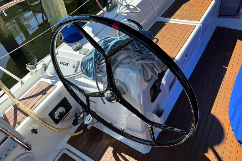 Slide: The Image of Steering wheel of 2019 Beneteau Oceanis 41.1 sailboat with coiled ropes on deck. - 4