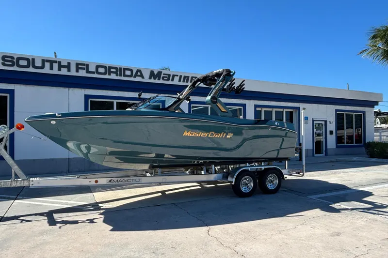 The Image of 2026 MasterCraft XT24 boat on trailer at South Florida Marine dealership. - 0