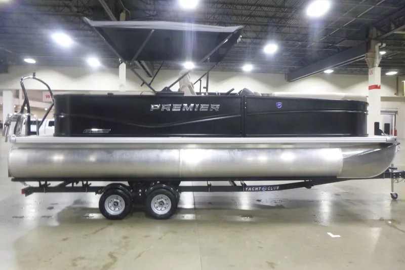 The Image of 2026 Premier 220 Sunscape RF pontoon boat on trailer in indoor showroom. - 1