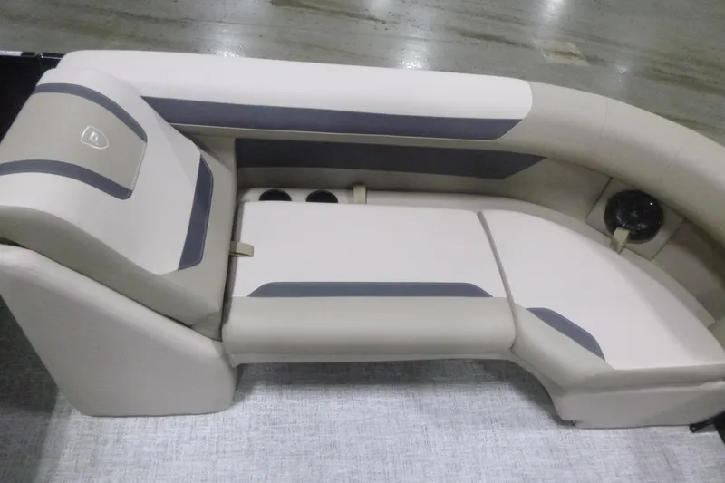 Slide: The Image of Premier 220 Sunscape RF 2026 boat seating, beige and gray upholstery, cup holders, and speaker. - 10