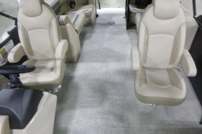 Slide: The Image of Interior of 2026 Premier 220 Sunscape RF boat with beige seating and steering console. - 13