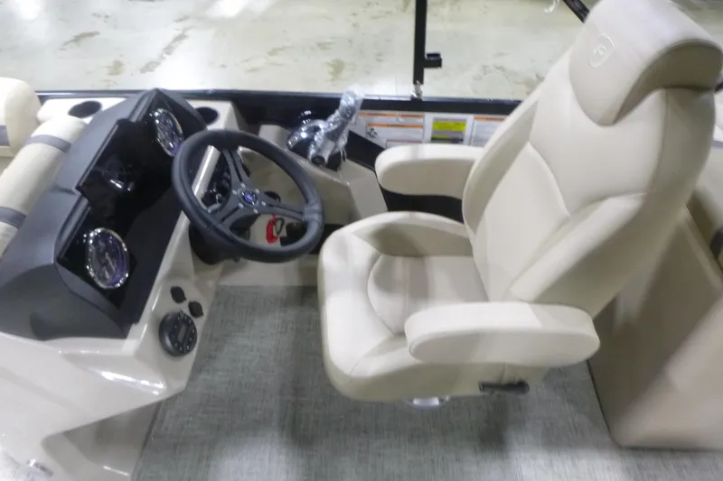 Slide: The Image of Captain's seat and dashboard of 2026 Premier 220 Sunscape RF boat, featuring modern controls. - 14