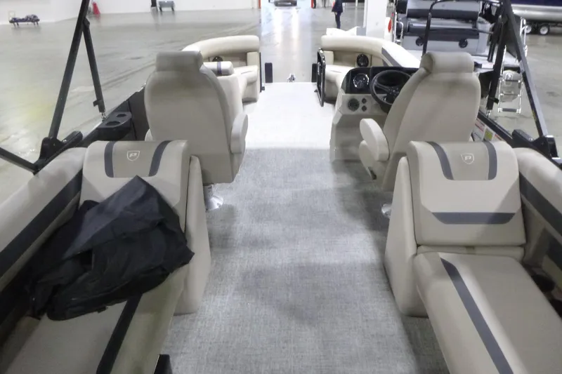 Slide: The Image of 2026 Premier 220 Sunscape RF boat interior with beige seating and modern dashboard. - 6