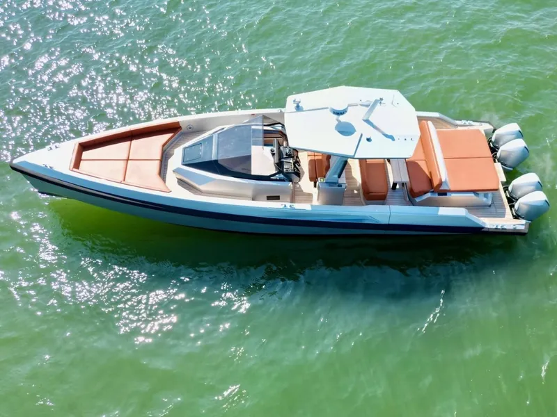 Slide: The Image of 2023 Wally 48 X luxury yacht on sparkling green water, aerial view. - 12