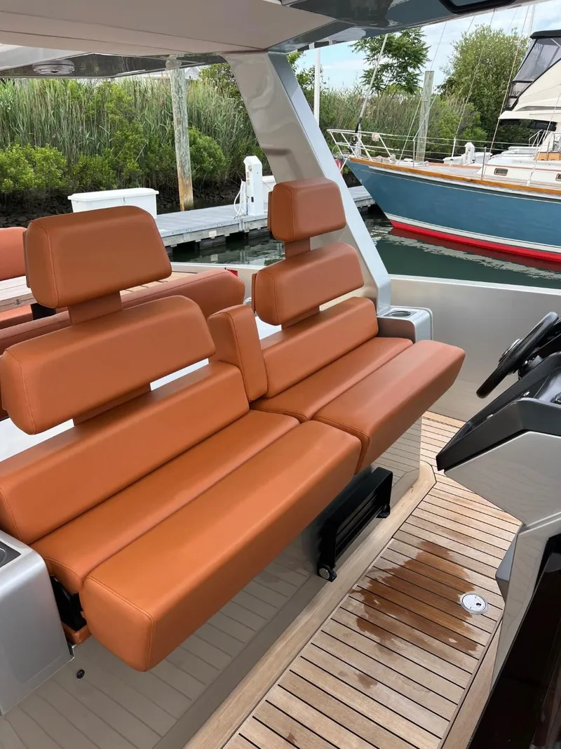 Slide: The Image of Luxury seating on 2023 Wally 48 X yacht with teak flooring, docked near other boats. - 25