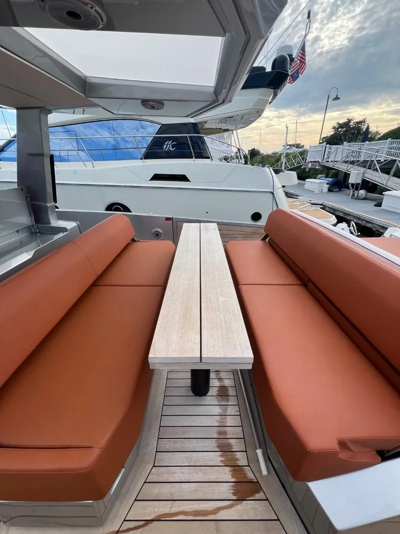 Slide: The Image of Luxurious seating area on 2023 Wally 48 X yacht with sleek design and wooden table. - 40
