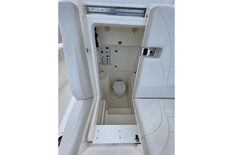 Slide: The Image of 2022 SeaVee 340Z boat interior with compact marine toilet and storage area. - 10