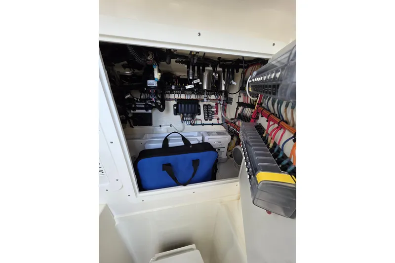 Slide: The Image of 2022 SeaVee 340Z electrical compartment with organized wiring and storage bag. - 11