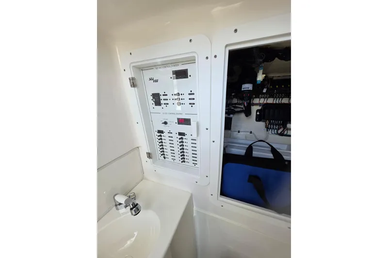 Slide: The Image of 2022 SeaVee 340Z electrical control panel and sink area. - 12