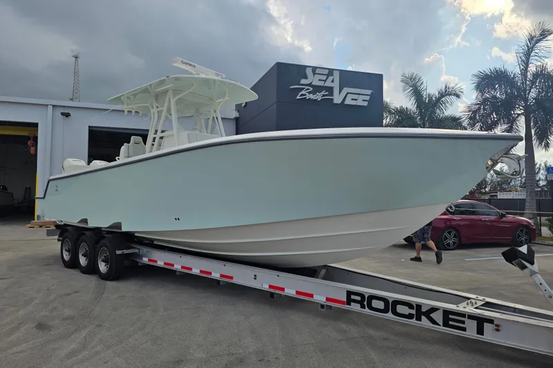 Slide: The Image of 2022 SeaVee 340Z boat on trailer at dealership, under cloudy sky. - 16