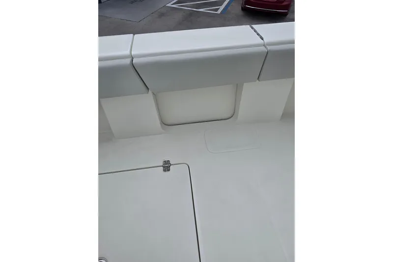 Slide: The Image of 2022 SeaVee 340Z boat interior detail with cushioned seating and storage compartment. - 19