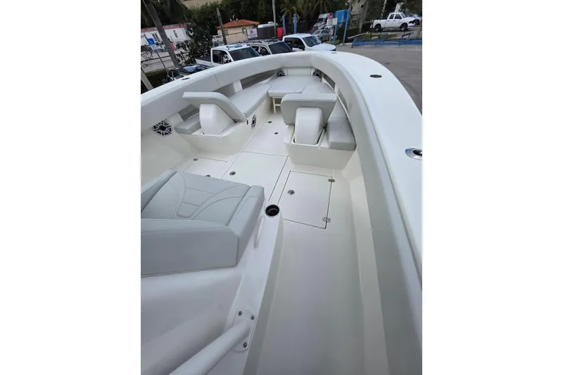 Slide: The Image of 2022 SeaVee 340Z boat interior with white seating and spacious deck layout. - 7