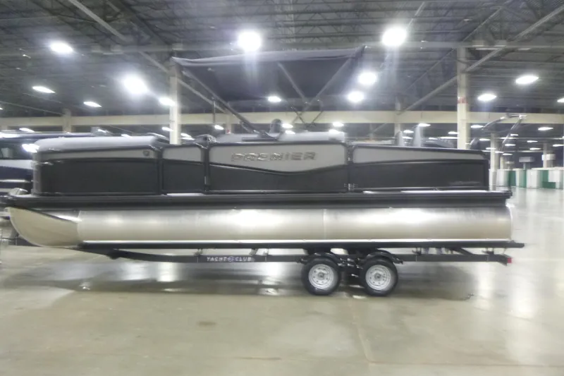 The Image of 2026 Premier 230 Sunsation RS pontoon boat on trailer in indoor showroom. - 1