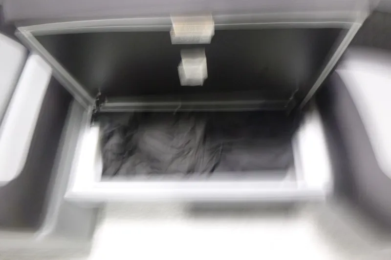 Slide: The Image of Open storage compartment in 2026 Premier 230 Sunsation RS boat interior. - 11