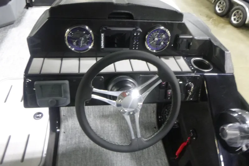 Slide: The Image of 2026 Premier 230 Sunsation RS boat dashboard with steering wheel and gauges. - 15