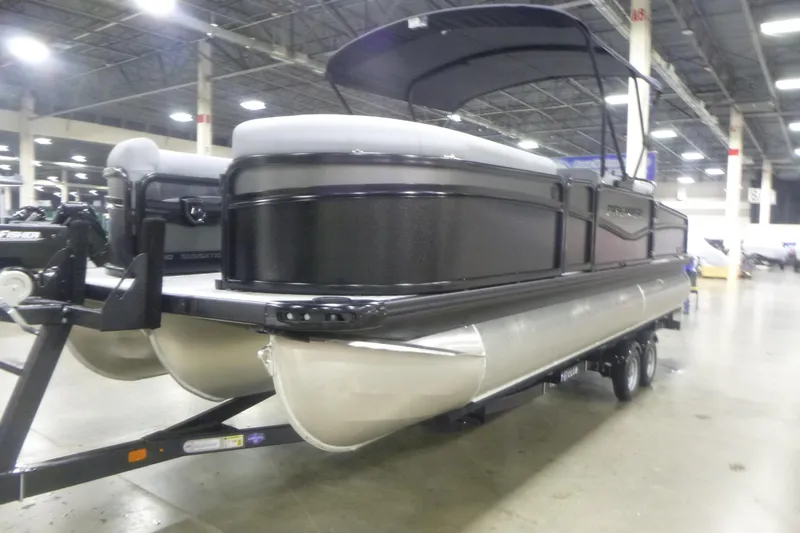 Slide: The Image of 2026 Premier 230 Sunsation RS pontoon boat displayed indoors on a trailer. - 3