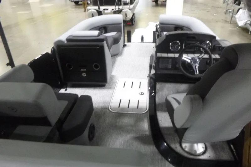 Slide: The Image of Interior of 2026 Premier 230 Sunsation RS pontoon boat with modern seating and steering console. - 6