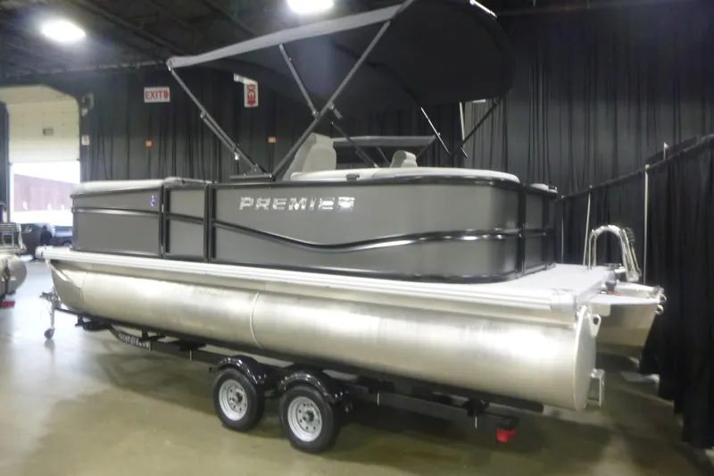 The Image of 2026 Premier 200 Sunscape RF pontoon boat displayed indoors on a trailer. - 1