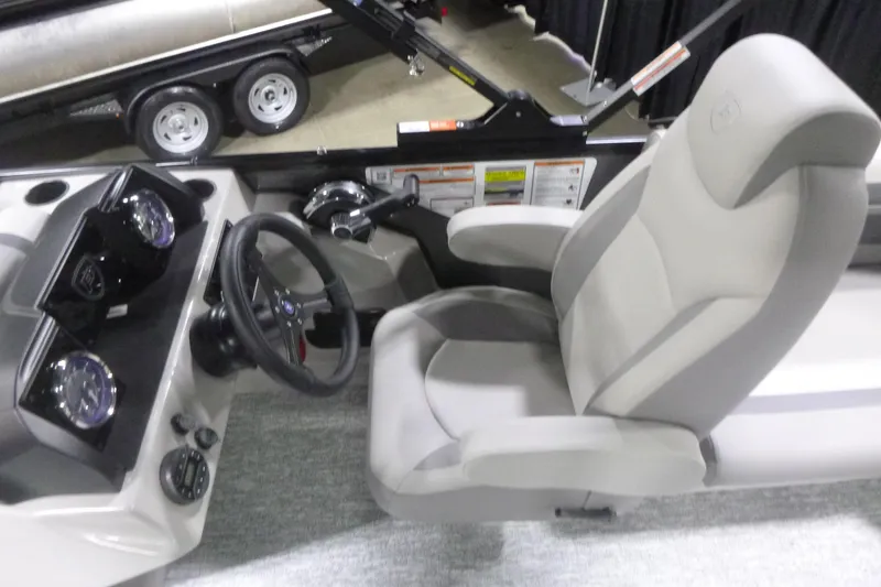Slide: The Image of Interior of 2026 Premier 200 Sunscape RF boat, featuring steering wheel and dashboard controls. - 13