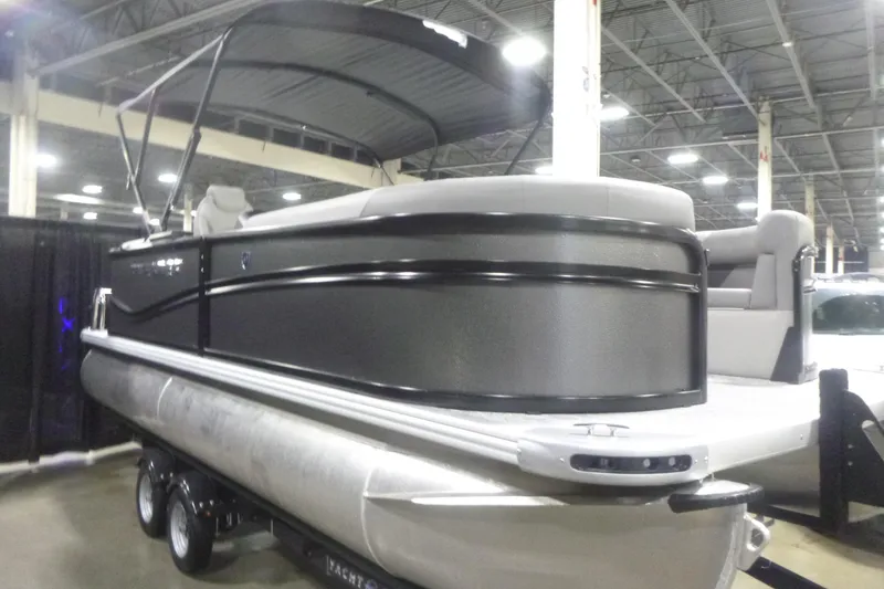 Slide: The Image of 2026 Premier 200 Sunscape RF pontoon boat displayed indoors on a trailer. - 2
