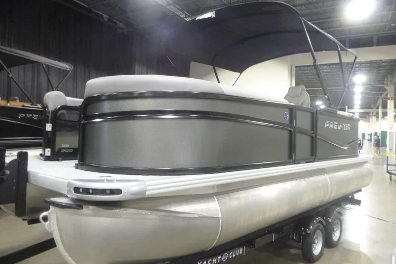 Slide: The Image of 2026 Premier 200 Sunscape RF pontoon boat displayed indoors on a trailer. - 3