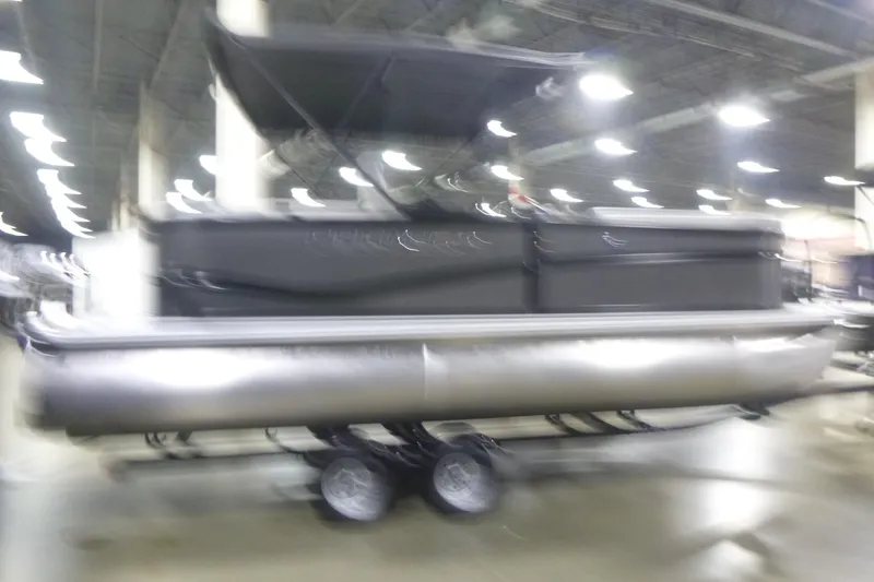Slide: The Image of Blurry image of a 2026 Premier 200 Sunscape RF pontoon boat indoors. - 4