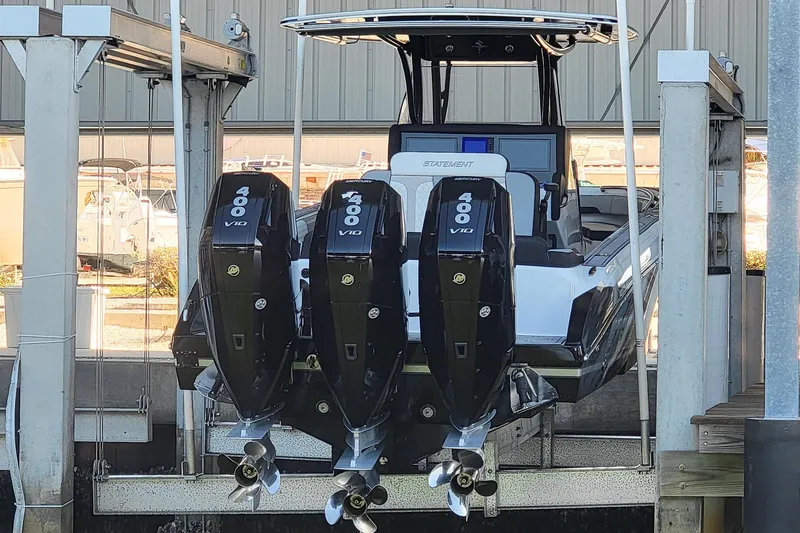 Slide: The Image of 2024 Statement 350 Open boat with triple Mercury 400 V10 engines in a marina lift. - 5