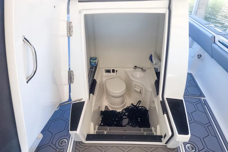 Slide: The Image of 2024 Statement 350 Open boat interior with compact bathroom and storage space. - 8